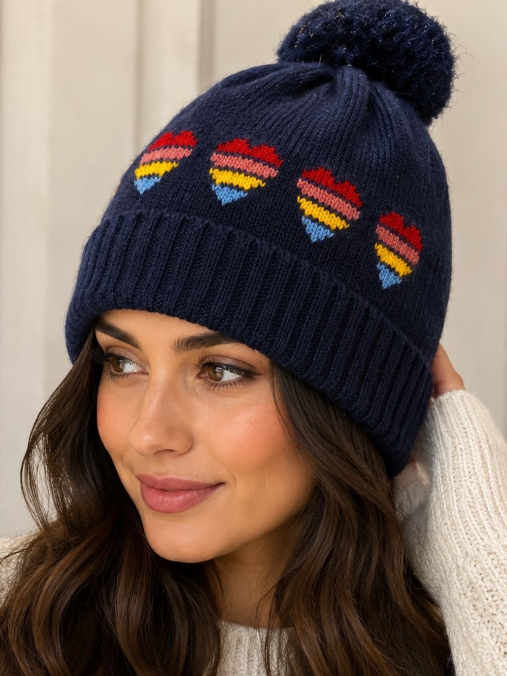 Accessorize Navy Pom-Pom Hat with Red, Yellow & Blue Heart Stripes